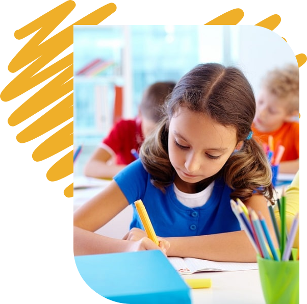 A girl drawing at her school desk